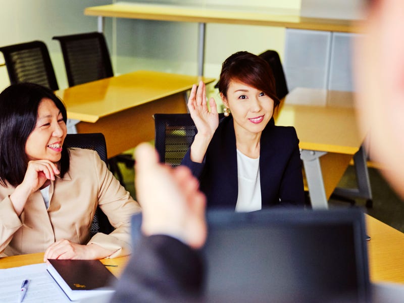 Dos mujeres en una reunión de trabajo formal.