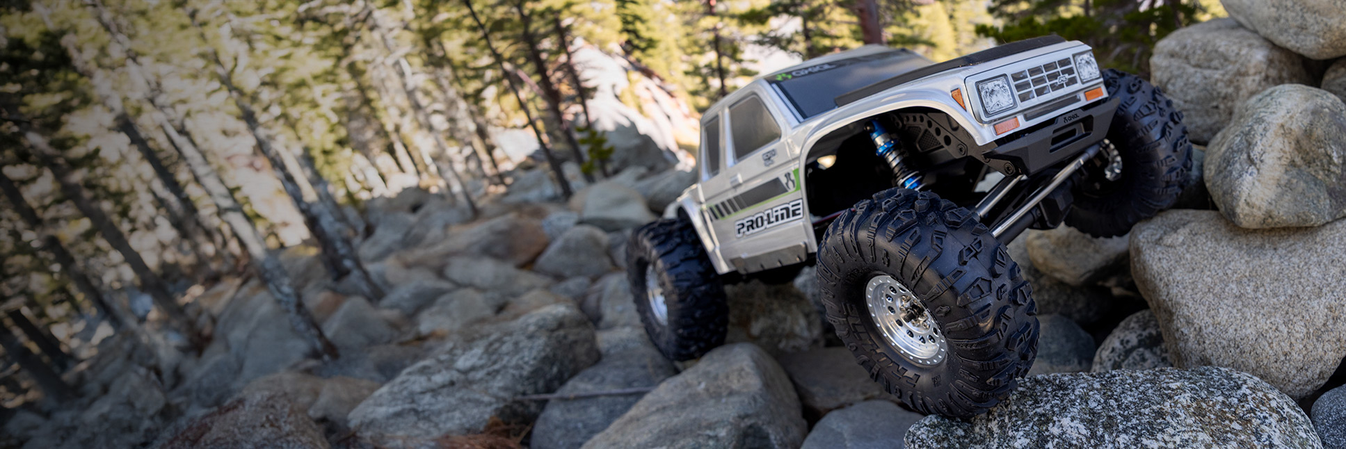 RC Truck crawling with the Pro-Line Chisel II Front Rear RC Crawler Tires on rocks in a forest RC Truck crawling with the Pro-Line Chisel II Front Rear RC Crawler Tires on rocks in a forest
