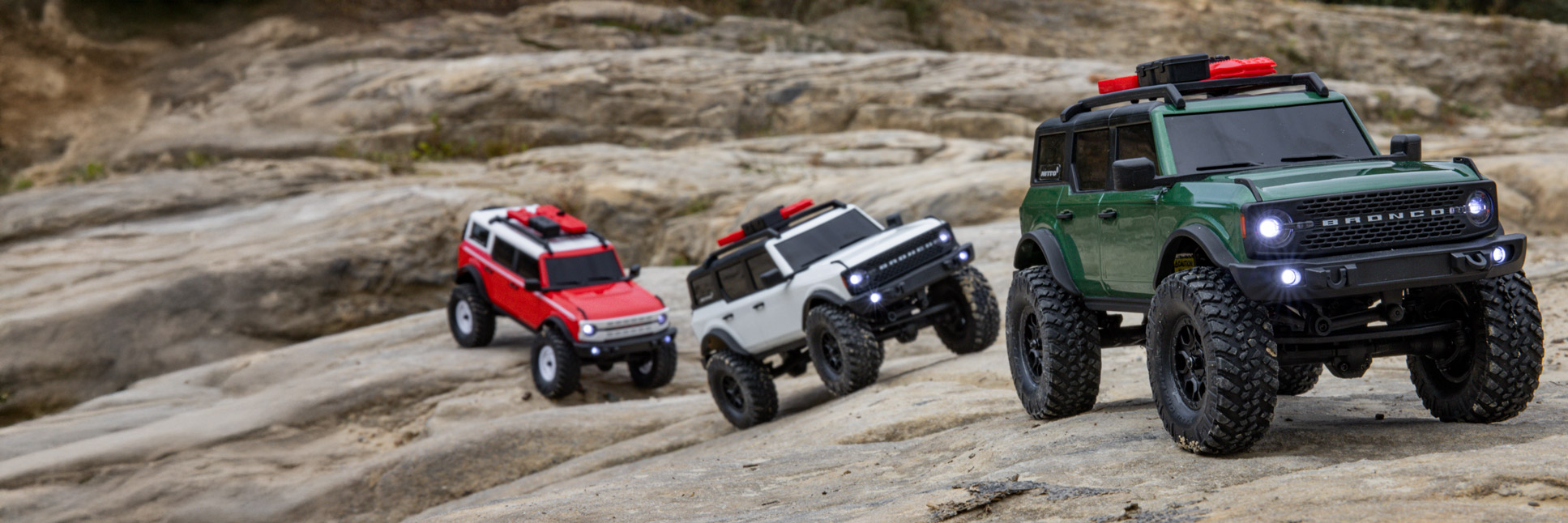 Action shot of the Axial 1/24 SCX24 Ford Bronco RC Rock Crawler climbing over rocky terrain Action shot of the Axial 1/24 SCX24 Ford Bronco RC Rock Crawler climbing over rocky terrain