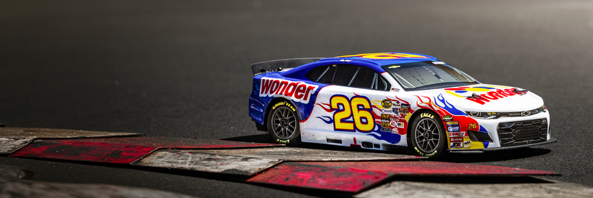 Action shot of the 1/12 Losi NASCAR Ricky Bobby No. 26 2026 Wonder Bread Chevrolet ZL1 Ready-to-Run RC Race Car racing on the asphalt track Action shot of the 1/12 Losi NASCAR Ricky Bobby No. 26 2026 Wonder Bread Chevrolet ZL1 Ready-to-Run RC Race Car racing on the asphalt track
