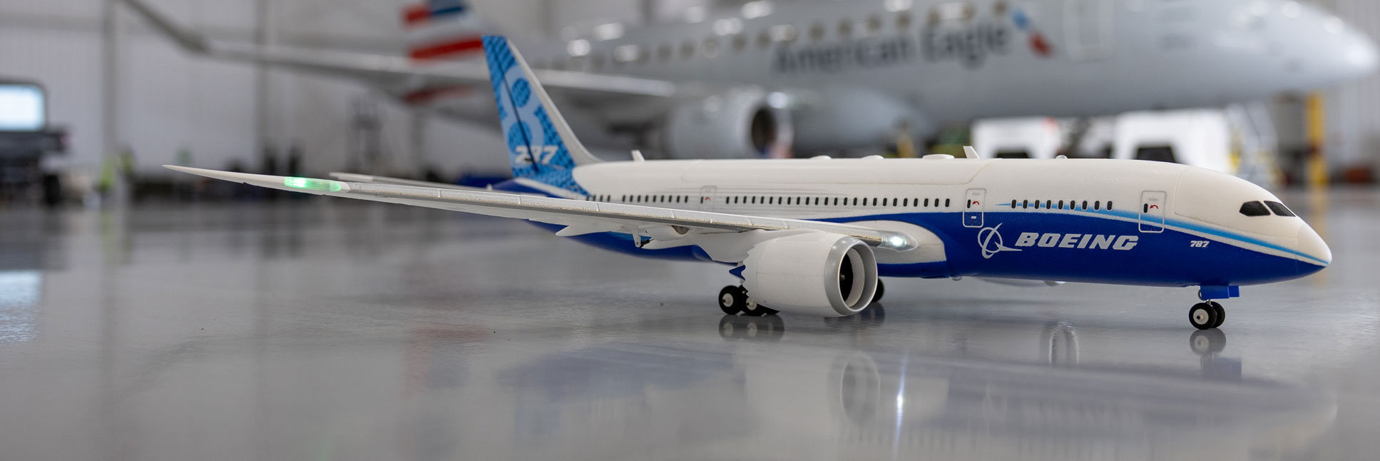 Action shot of the E-flite Micro Boeing 787 Dreamliner Twin 30mm EDF Bind-N-Fly Basic with AS3X and SAFE Select RC Airplane inside a hangar