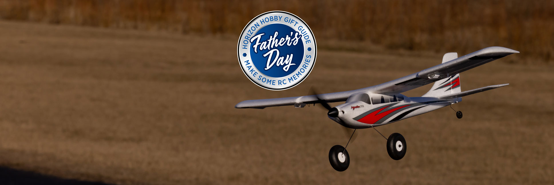 HobbyZone Apprentice STOL S 700mm RC Airplane flying through the sky with the Horizon Hobby Father's Day Logo