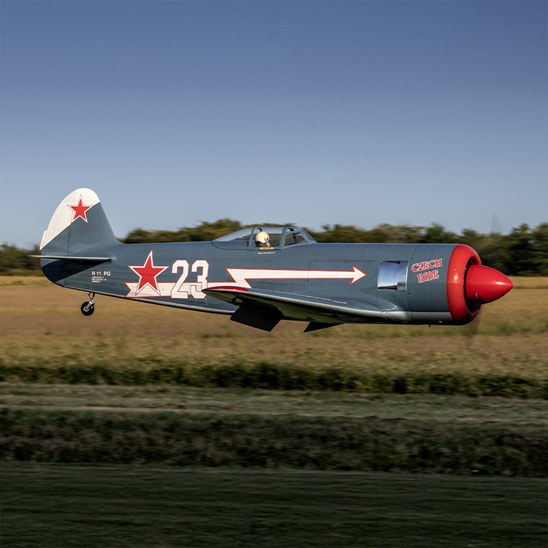 RC Warbird flying through the air