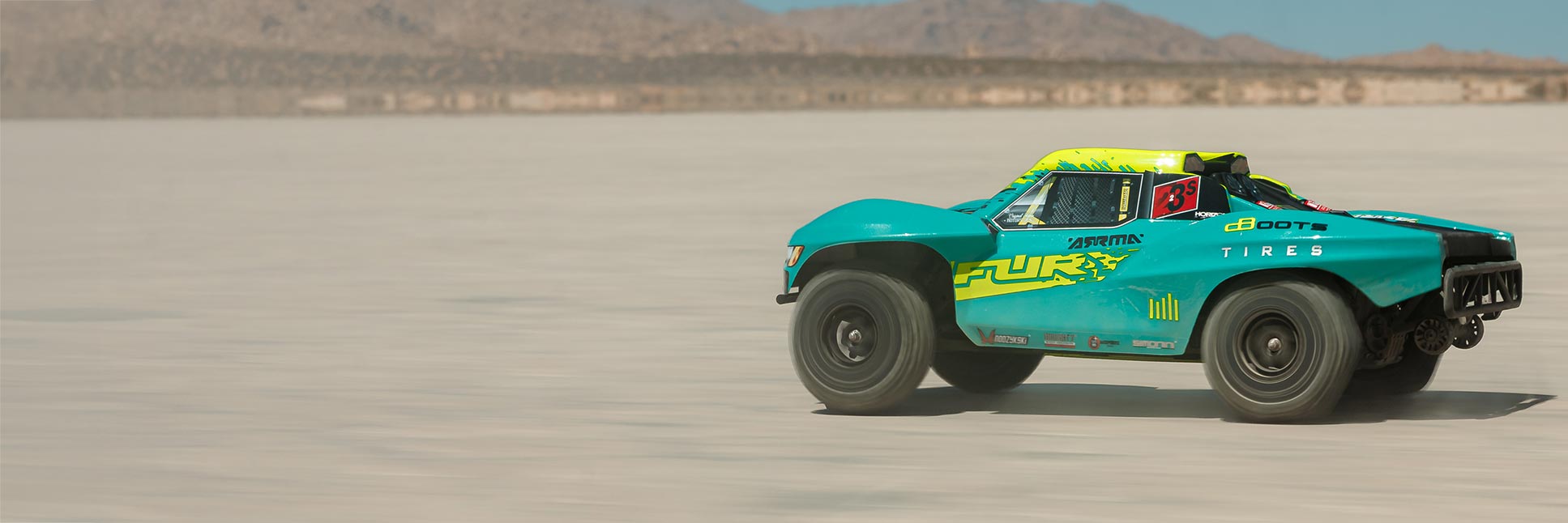 Action shot of the ARRMA 1/10 FURY 223S DSC 2WD Ready-To-Run Brushless Short Course Truck bashing through the dirt Action shot of the ARRMA 1/10 FURY 223S DSC 2WD Ready-To-Run Brushless Short Course Truck bashing through the dirt