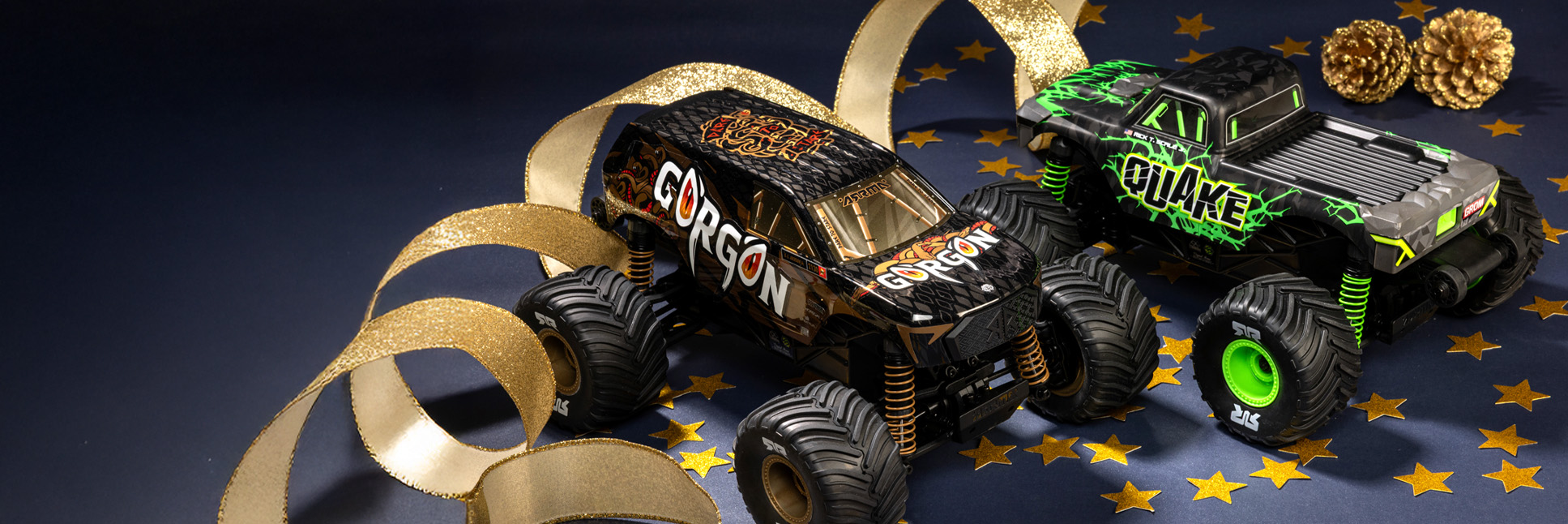 Glamour shot of the ARRMA QUAKE GROM and GORGON GROM 2WD Brushed RC Monster Trucks with a festive holiday themed background Glamour shot of the ARRMA QUAKE GROM and GORGON GROM 2WD Brushed RC Monster Trucks with a festive holiday themed background