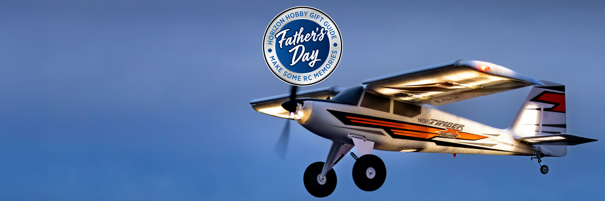E-flite Night Timber X Evolution 1.2m RC Airplane flying through the night sky with the Horizon Hobby Father's Day Logo