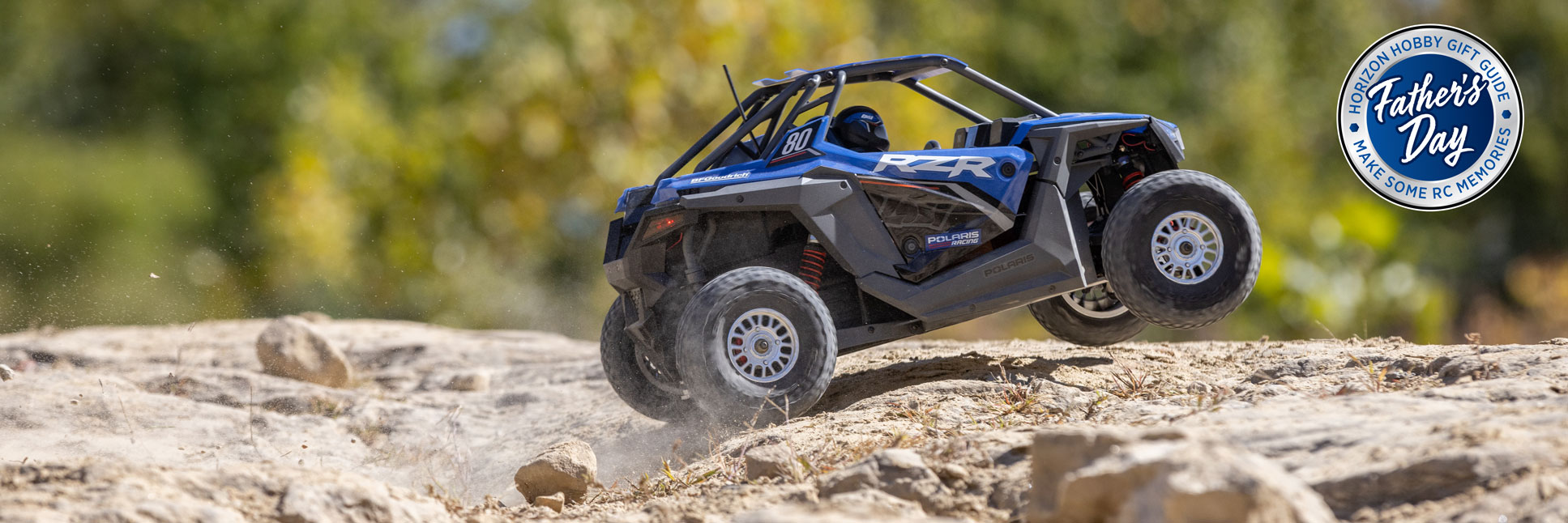 Action shot of the Losi 1/10 RZR Rey Polaris 3S 4X4 Ready-To-Run Brushless RC Side by Side with the Horizon Hobby Father's Day Logo Action shot of the Losi 1/10 RZR Rey Polaris 3S 4X4 Ready-To-Run Brushless RC Side by Side with the Horizon Hobby Father's Day Logo