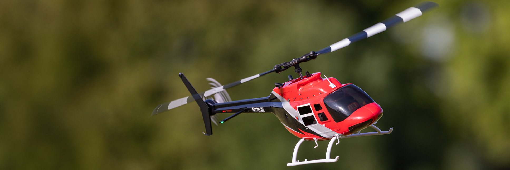 Action shot of the Blade® Bell 206 Jet Ranger 235 CP RC helicopter hovering in the air