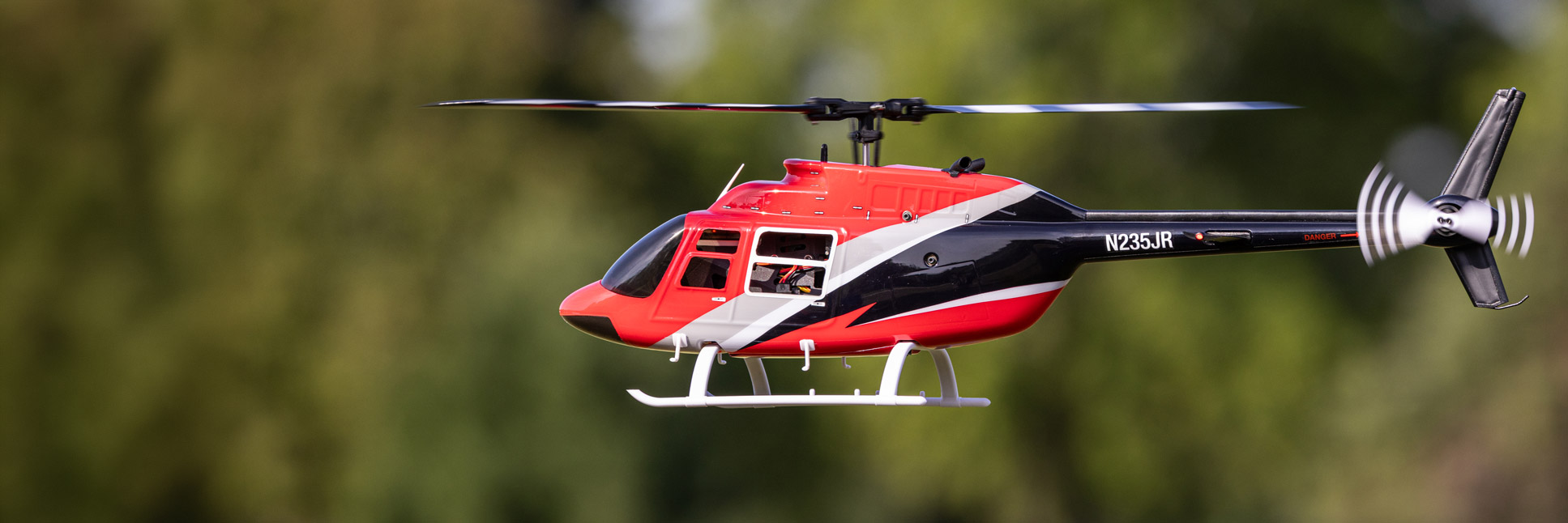 Action shot of the Blade® Bell 206 Jet Ranger 235 CP RC helicopter hovering in the air
