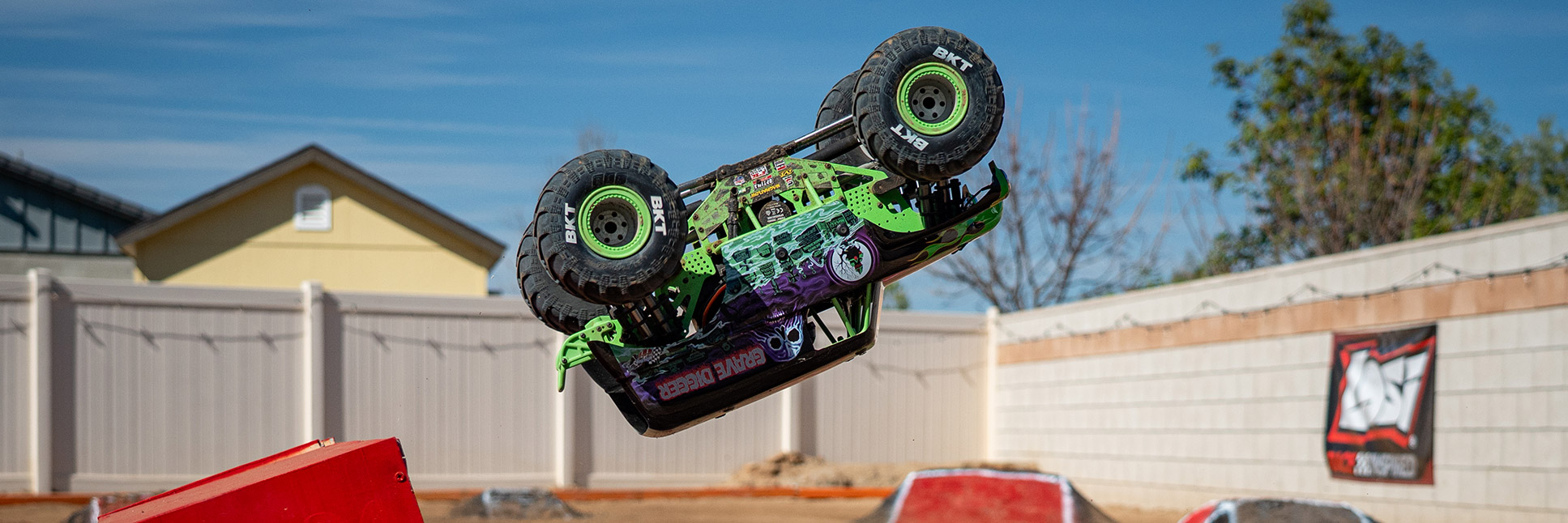 Losi 1/8 LMT 2.0 4X4 Solid Axle Brushless Monster Truck Ready-to-Run RC Performing Stunt in Dirt Backyard