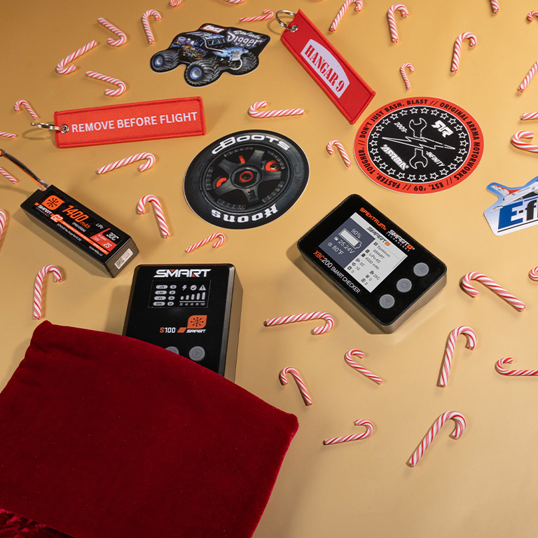 Holiday Headquarters Stocking Stuffers like Spektrum Accessories and Horizon Hobby Brand Stickers with festive holiday themed background