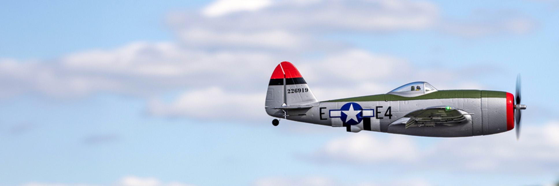 Action shot of the E-flite Micro P-47 Thunderbolt 625mm BNF Basic with AS3X+ and SAFE Select RC Aircraft flying in the air Action shot of the E-flite Micro P-47 Thunderbolt 625mm BNF Basic with AS3X+ and SAFE Select RC Aircraft flying in the air