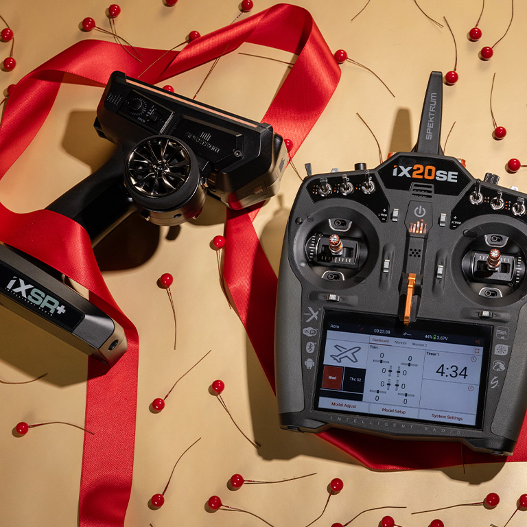 Spektrum iXSR Surface Transmitter and iX20 Special Edition Aircraft Transmitter in a holiday themed setting