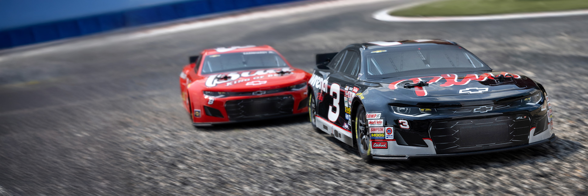 Action shot of the 1/12 NASCAR RC Race Car RCR No. 3 GM Goodwrench Chevrolet ZL1 2S AWD RTR and Dale Earnhardt Jr. No. 8 Budweiser Chevrolet ZL1 2S AWD RTR Brushed On-Road