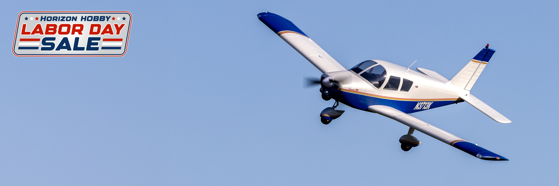 Action Shot of the E-flite Cherokee 1.3M Blue Bind-N-Fly Basic RC Airplane AS3X+ and SAFE Select with the Labor Day Sale Logo Action Shot of the E-flite Cherokee 1.3M Blue Bind-N-Fly Basic RC Airplane AS3X+ and SAFE Select with the Labor Day Sale Logo
