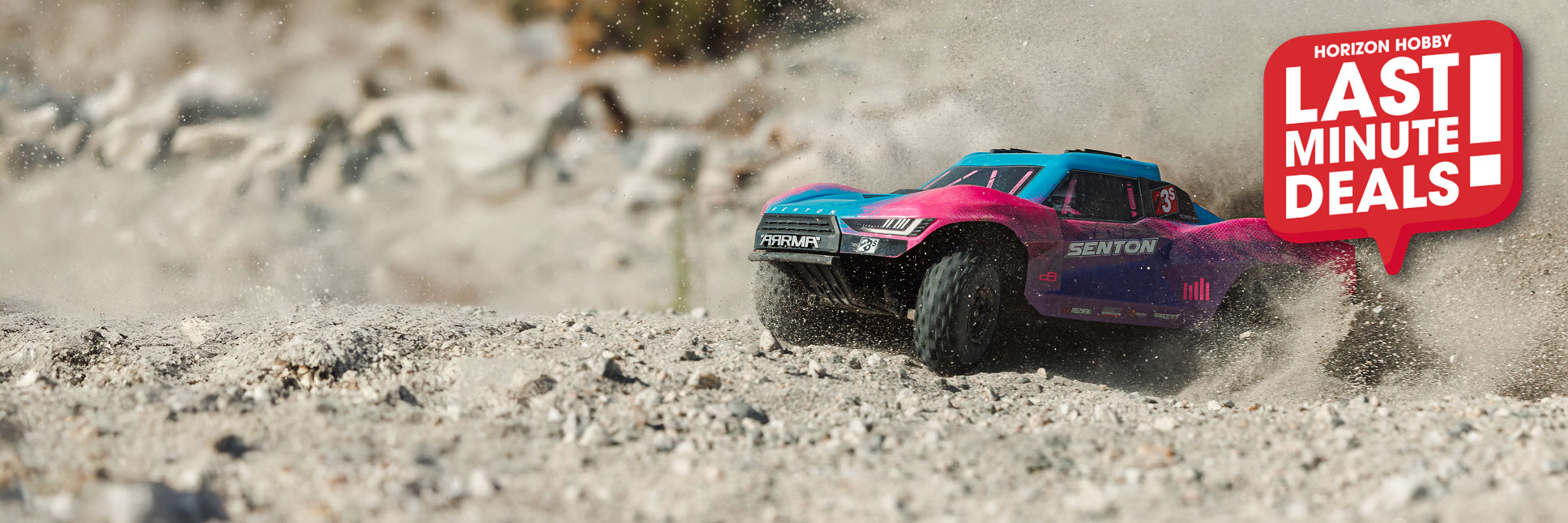 Action shot of the ARRMA 1/10 SENTON DSC 223S RC Short Course Truck bashing through dirt terrain with the Last Minute Deals logo