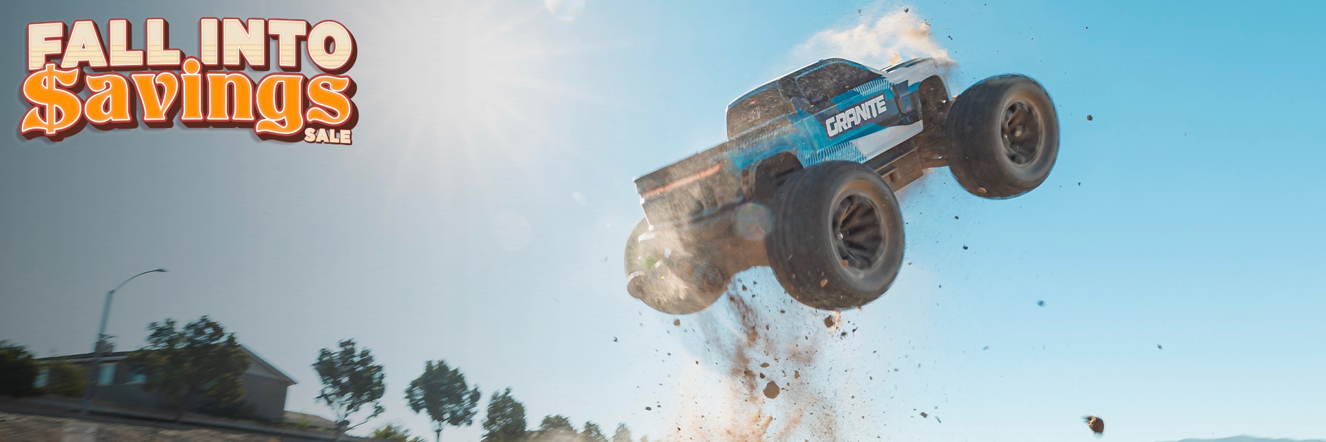 Action Shot of the ARRMA 1/10 GRANITE 223S 4X4 Ready-to-Run Brushless RC Monster Truck flying through the air with the Fall Into Savings RC Sale Logo
