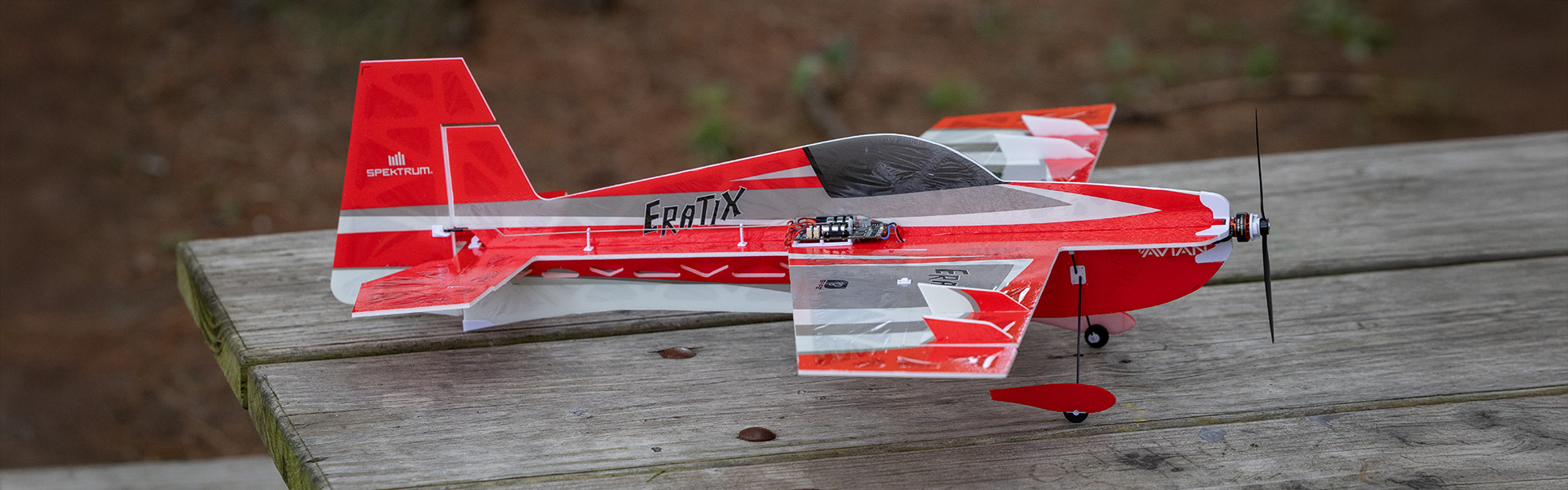 Order the E-flite UMX Eratix 3D FF (Flat Foamy) 450mm Bind-N-Fly Basic RC Airplane with AS3X and SAFE Select Now! Glamour shot of the E-flite UMX Eratix 3D FF (Flat Foamy) 450mm Bind-N-Fly Basic RC Airplane with AS3X and SAFE Select on a picnic table with a grassy background