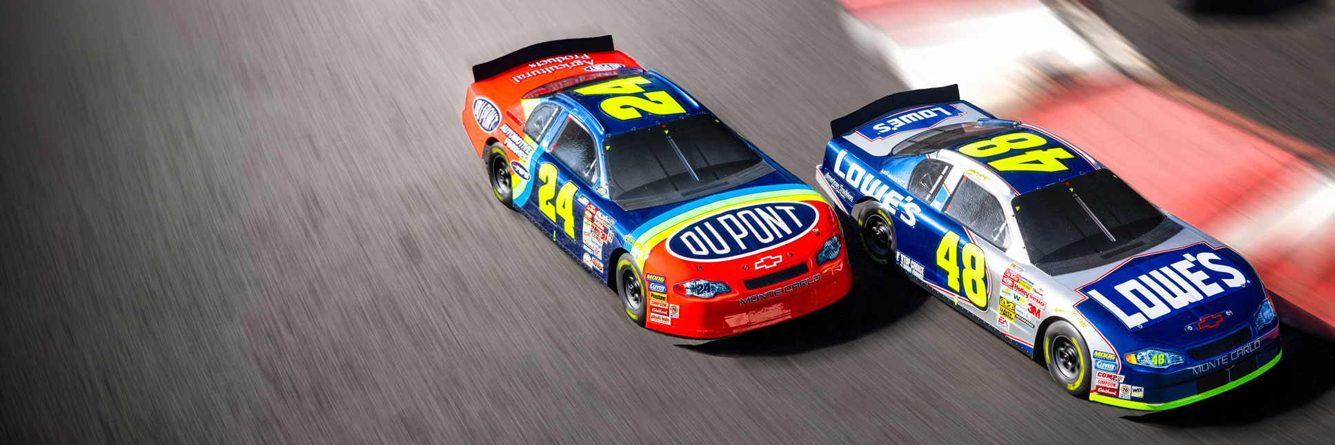 Action shot of the 1/12 Losi NASCAR Jeff Gordon No. 24 Dupont Chevrolet and Jeff Gordon No. 24 Monte Carlo racing on the asphalt track Action shot of the 1/12 Losi NASCAR Jeff Gordon No. 24 Dupont Chevrolet and Jeff Gordon No. 24 Monte Carlo racing on the asphalt track