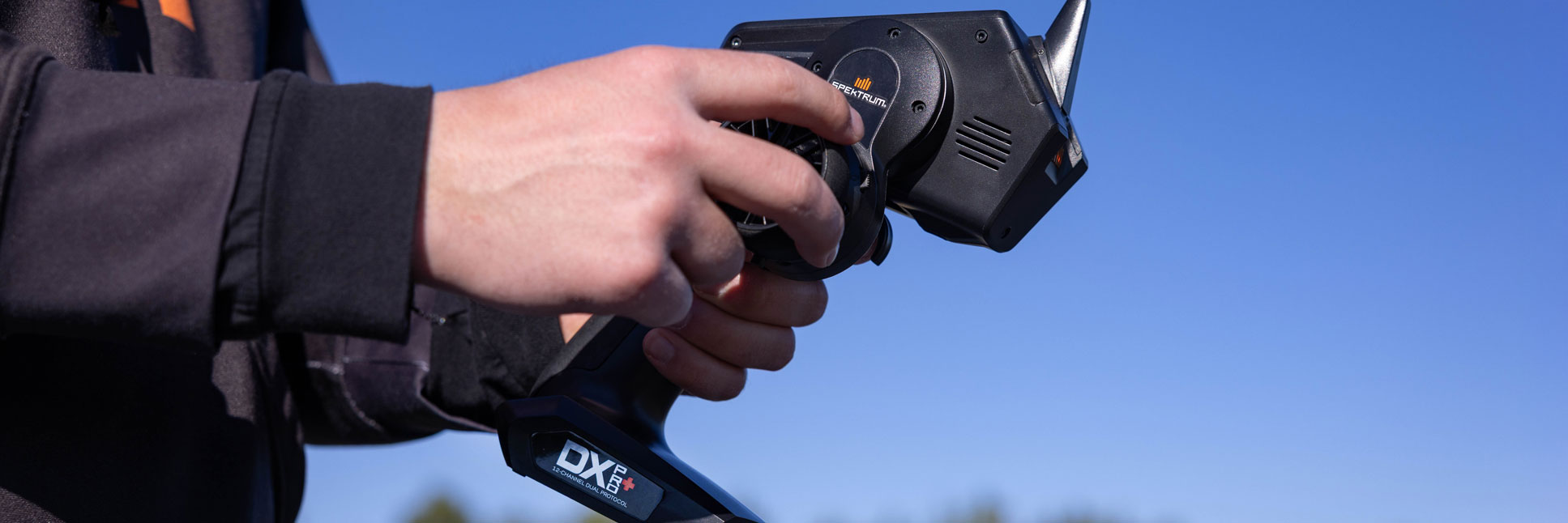 Action shot of a person using the Spektrum DX Pro+ 12-Channel DSMR+ Transmitter