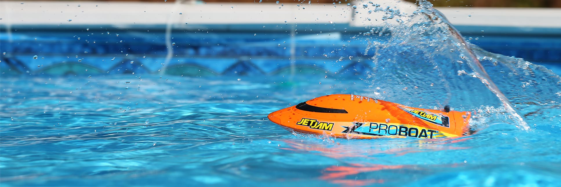 Action shot of the Pro Boat Jet Jam V2 12" Self-Righting Pool Racer Brushed Ready-To-Run RC boat floating in a pool of water Action shot of the Pro Boat Jet Jam V2 12" Self-Righting Pool Racer Brushed Ready-To-Run RC boat floating in a pool of water