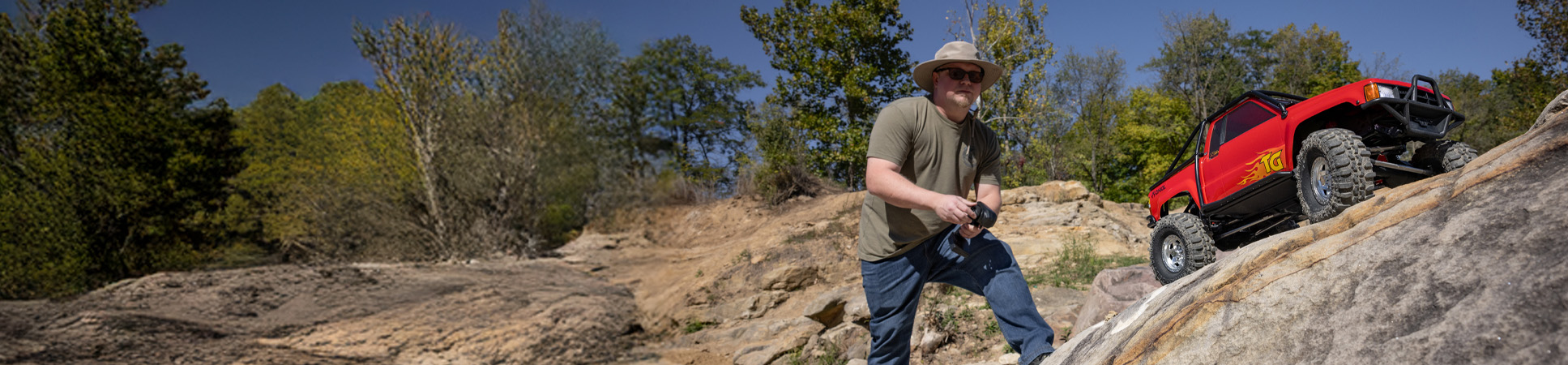 Action shot of a person driving the Axial SCX10 III 1987 Toyota SR5 Ready-to-Run RC Rock Crawler