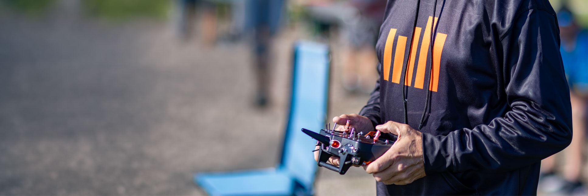 Action shot of a person in a Spektrum hoodie holding a transmitter