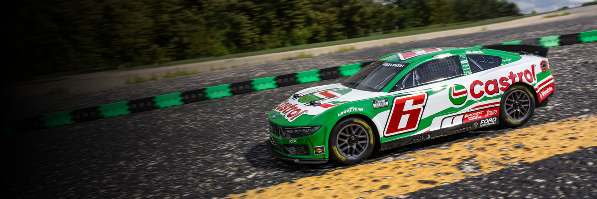 Action shot of the 1/12 Losi NASCAR Brad Keselowski No. 6 2026 Castrol Ford Mustang Ready-to-Run RC Race Car racing on the asphalt track