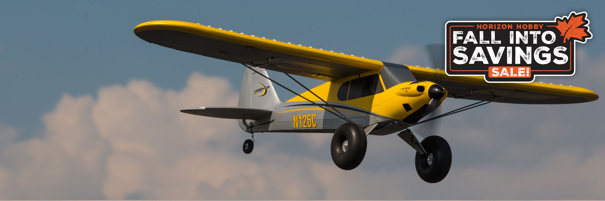 Action shot of the HobbyZone Carbon Cub S flying through the sky with the Horizon Hobby Fall Into Savings Logo
