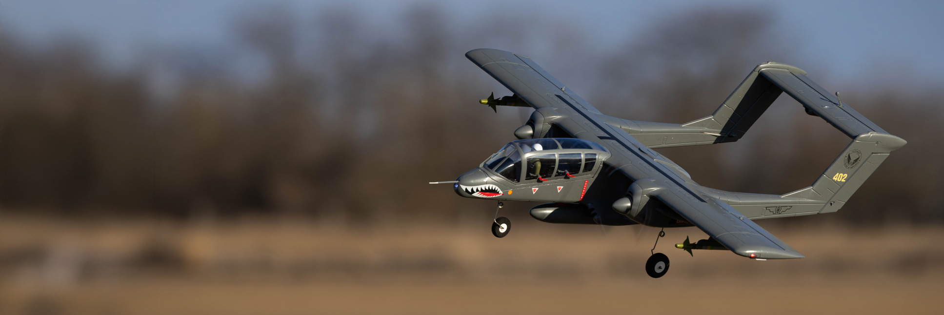 Action shot of the E-flite Micro OV-10 Bronco 645mm Bind-N-Fly Basic with AS3X and SAFE Select RC Aircraft flying through the air Action shot of the E-flite Micro OV-10 Bronco 645mm Bind-N-Fly Basic with AS3X and SAFE Select RC Aircraft flying through the air