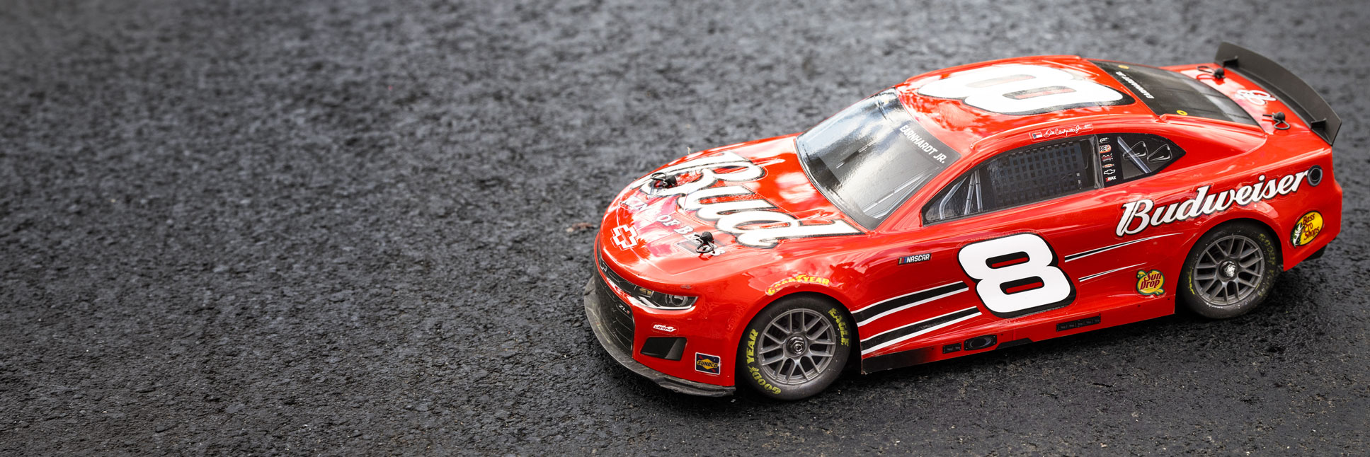 Action shot of the 1/12 NASCAR RC Race Car Dale Earnhardt Jr. No. 8 Budweiser Chevrolet ZL1 2S AWD Ready-To-Run Brushed On-Road on asphalt