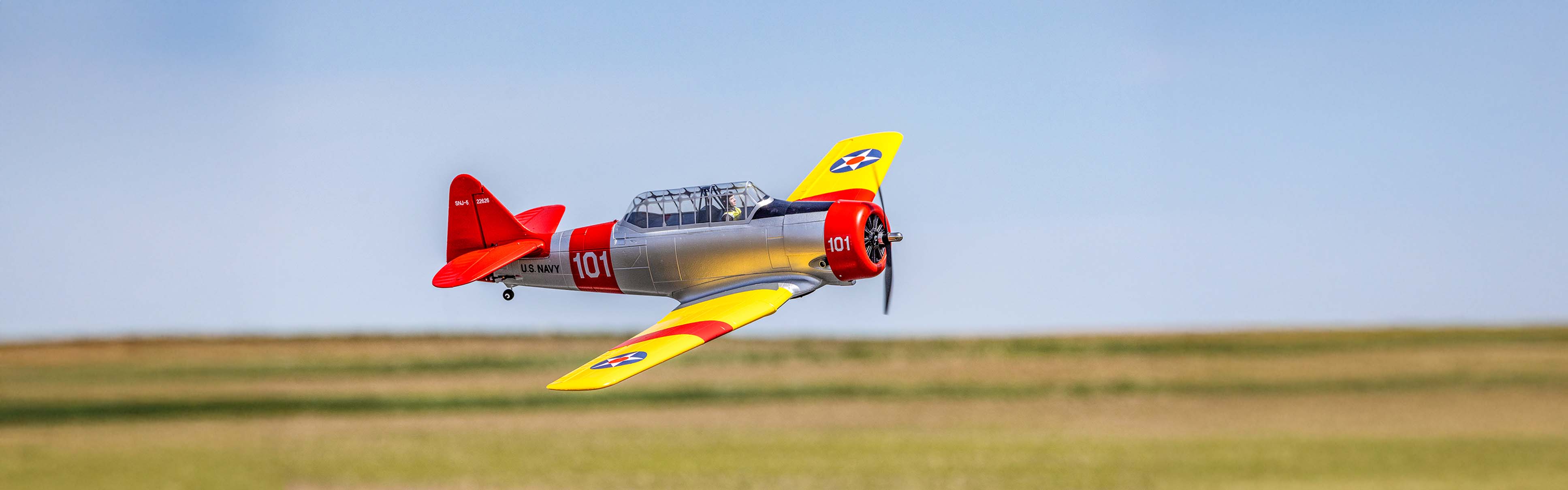 Action shot of the E-flite SNJ-5/AT-6 Texan 1.5m wingspan RC Warbird Airplane flying in the sky