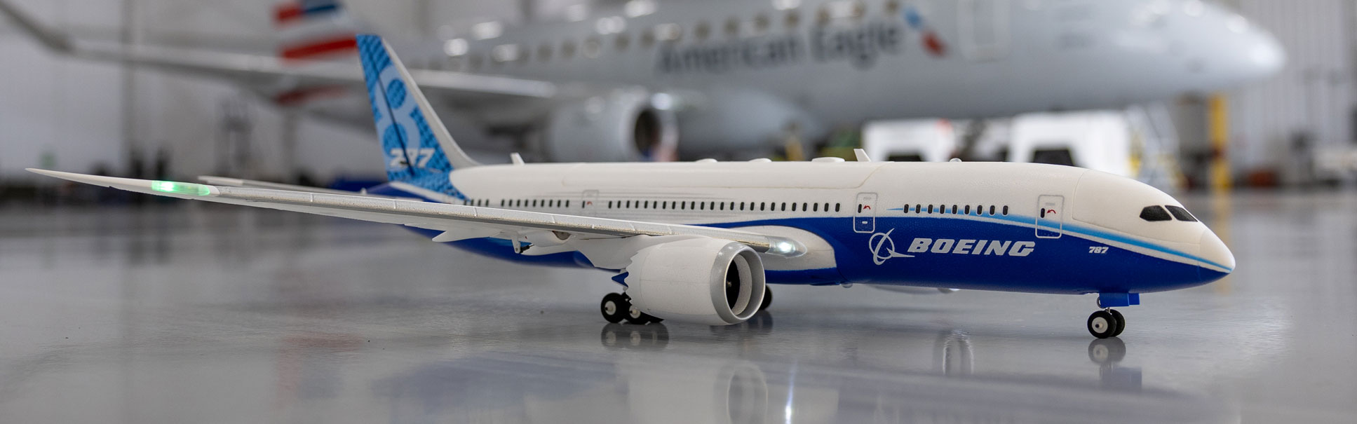 Order the E-flite Micro Boeing 787 Dreamliner Twin 30mm EDF Bind-N-Fly Basic with AS3X and SAFE Select Now! Action shot of the E-flite Micro Boeing 787 Dreamliner Twin 30mm EDF Bind-N-Fly Basic with AS3X and SAFE Select RC airplane in a hangar