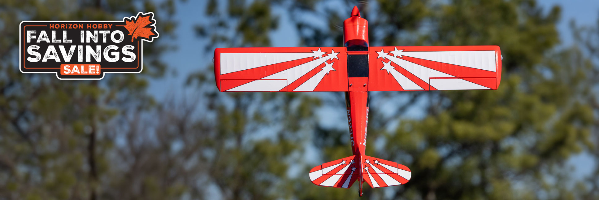 Action shot of the E-flite Super Decathlon 1.2m Bind-N-Fly Basic with AS3X+ and SAFE Select RC airplane flying through the sky with the Horizon Hobby Fall Into Savings Logo Action shot of the E-flite Super Decathlon 1.2m Bind-N-Fly Basic with AS3X+ and SAFE Select RC airplane flying through the sky with the Horizon Hobby Fall Into Savings Logo