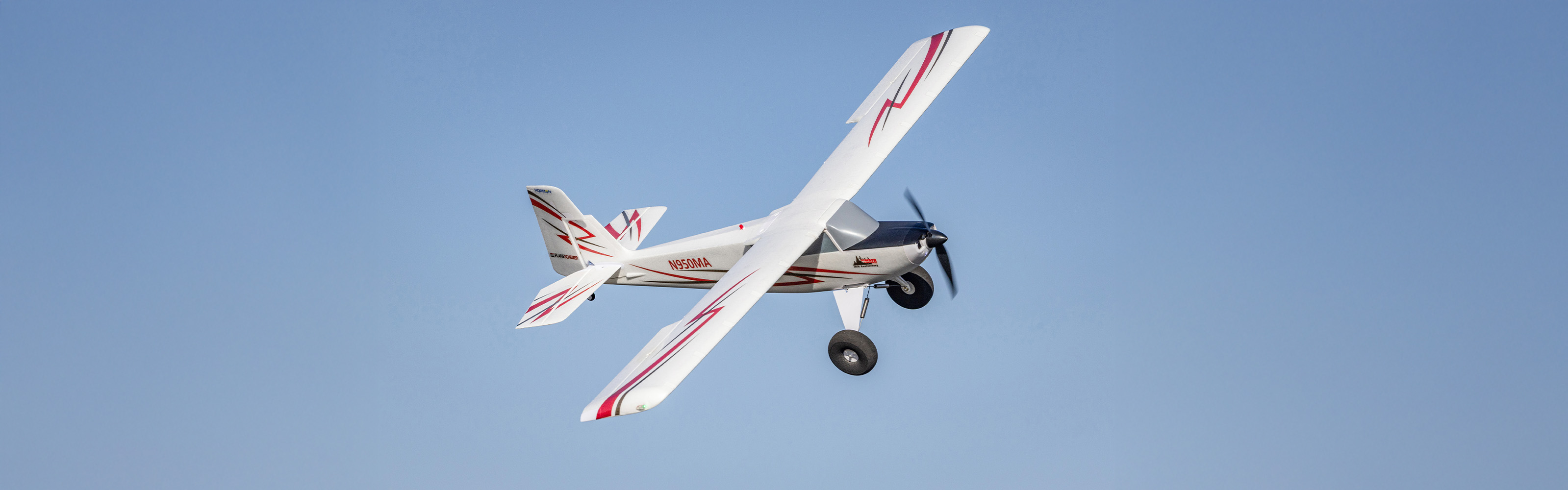 Action shot of the E-flite Timber 1.5m 10th Anniversary Special Edition RC Airplane flying through the sky