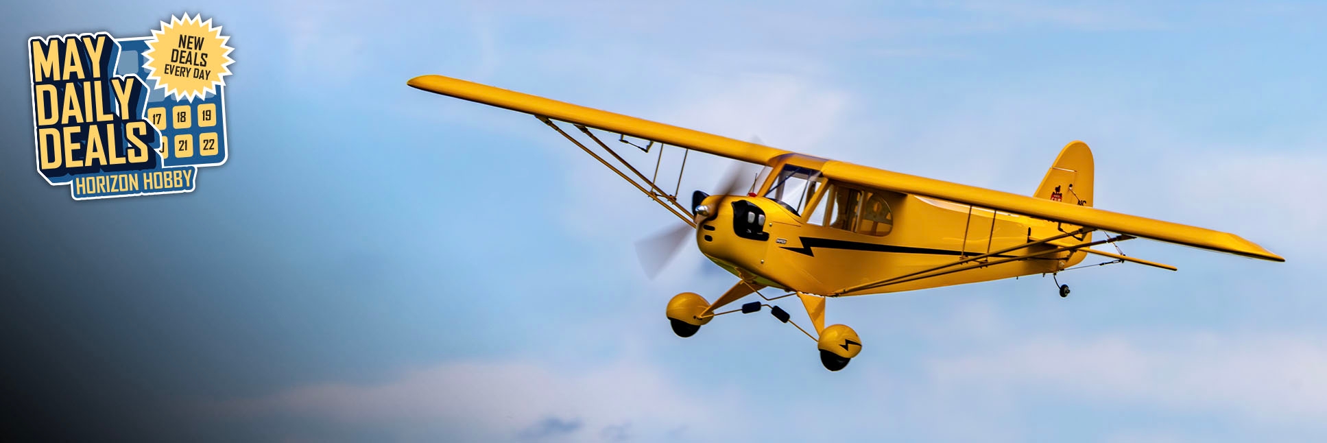 Action shot of Hangar 9 J-3 Cub 10cc Almost-Ready-To-Fly 82.5 inch wingspan RC Airplane with the May Daily Deals Logo Action shot of Hangar 9 J-3 Cub 10cc Almost-Ready-To-Fly 82.5 inch wingspan RC Airplane with the May Daily Deals Logo