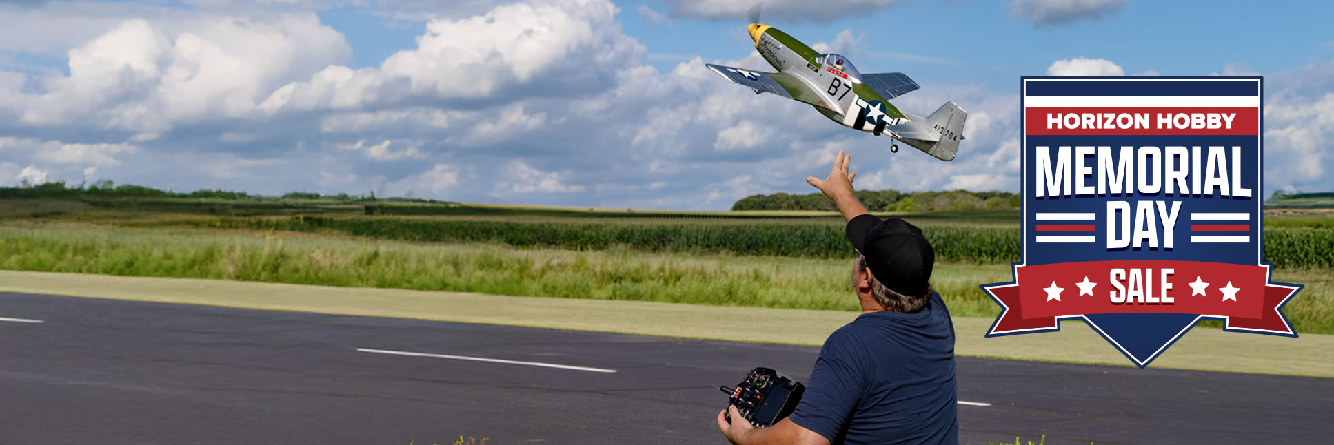 Action shot of E-flite P-51D Mustang 1.0M Bind-N-Fly Basic RC Plane AS3X and SAFE Select with the Memorial Day Sale Logo Action shot of E-flite P-51D Mustang 1.0M Bind-N-Fly Basic RC Plane AS3X and SAFE Select with the Memorial Day Sale Logo