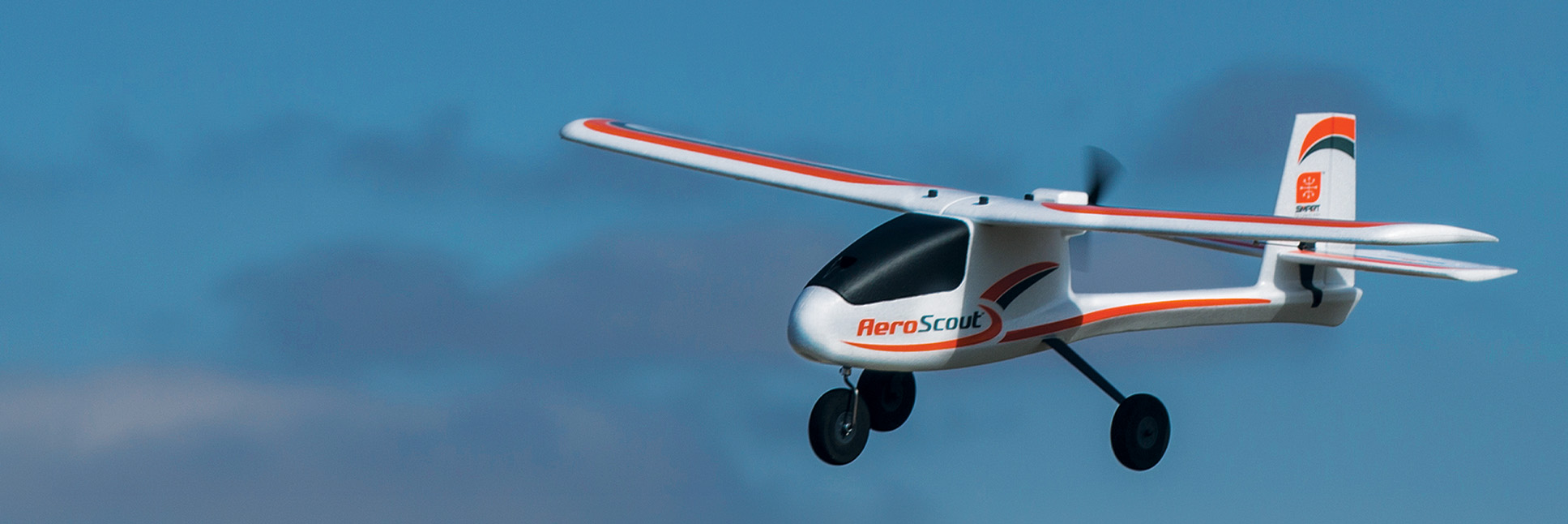 Action shot of the HobbyZone AeroScout S 2 1.1m RC airplane flying through the sky