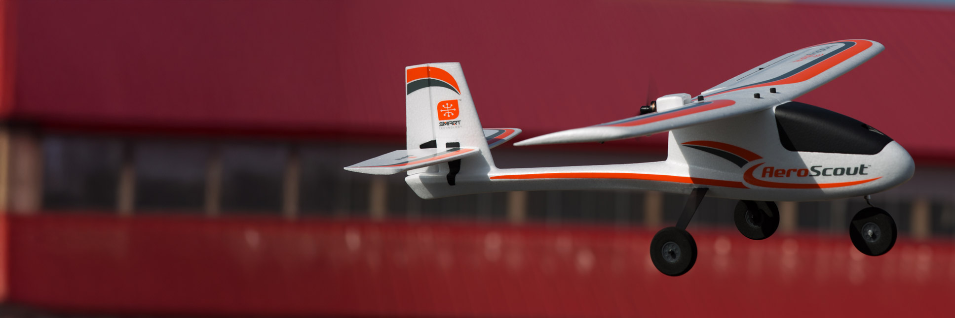 Action shot of the HobbyZone AeroScout S 2 1.1m RC airplane flying through the sky