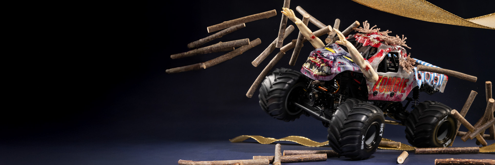 Glamour shot of the Losi Mini-LMT Zombie RC Monster Truck and the E-flite Micro Scrappy 800mm RC Airplane with a festive holiday themed background Glamour shot of the Losi Mini-LMT Zombie RC Monster Truck and the E-flite Micro Scrappy 800mm RC Airplane with a festive holiday themed background