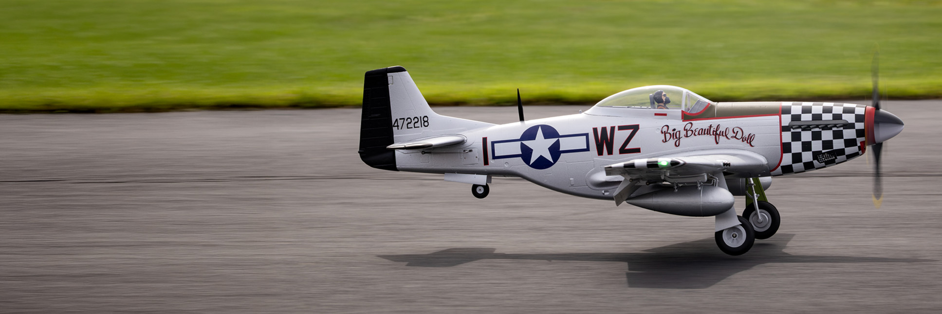 Action shot of the E-flite P-51D Mustang "Big Beautiful Doll" 1.5m warbird flying in the air