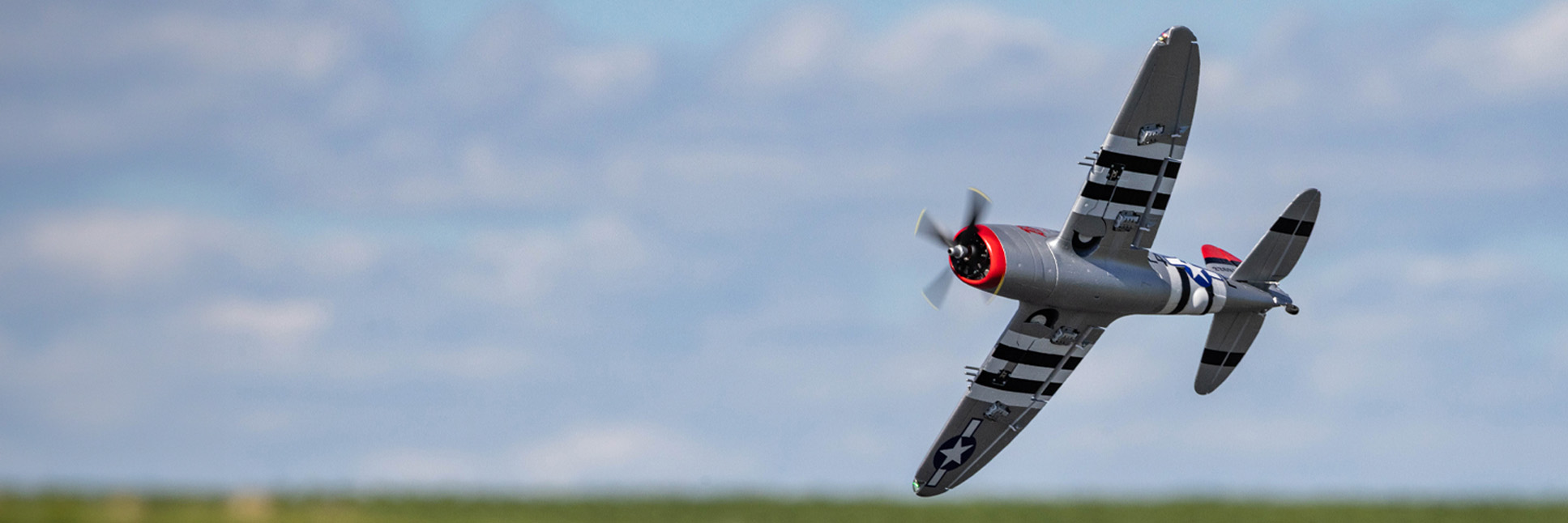 Action shot of the E-flite Micro P-47 Thunderbolt 625mm Bind-N-Fly Basic RC warbird flying through the air Action shot of the E-flite Micro P-47 Thunderbolt 625mm Bind-N-Fly Basic RC warbird flying through the air
