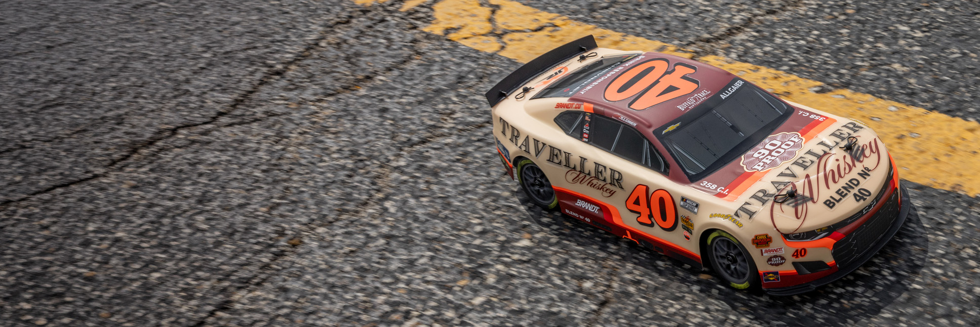 Action shot of the Losi 1/12 NASCAR RC Race Car Justin Allgaier No. 40 2026 Traveller Whiskey Chevrolet ZL1 2S AWD RTR Brushed On-Road speeding on blacktop Action shot of the Losi 1/12 NASCAR RC Race Car Justin Allgaier No. 40 2026 Traveller Whiskey Chevrolet ZL1 2S AWD RTR Brushed On-Road speeding on blacktop