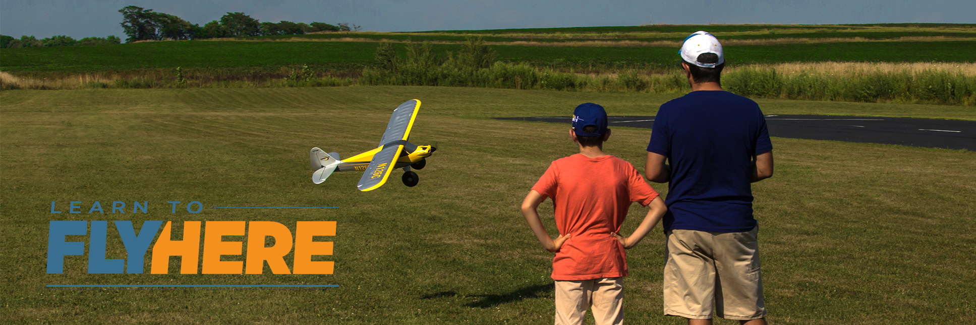 Learn To Fly Banner with Father and Son flying an RC plane together Learn To Fly Banner with Father and Son flying an RC plane together