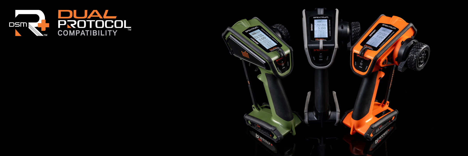 Glamour shot of the Spektrum DX Rugged+ 12-Channel DSMR+ Transmitters on a black background with the DSMR+ and Dual Protocol Logo Glamour shot of the Spektrum DX Rugged+ 12-Channel DSMR+ Transmitters on a black background with the DSMR+ and Dual Protocol Logo