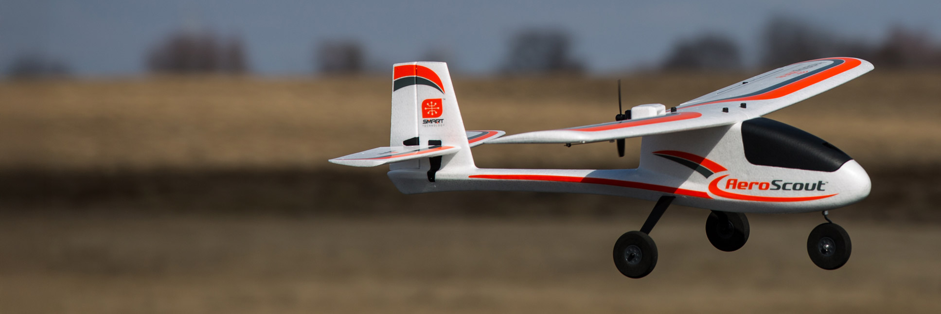 Action shot of the HobbyZone AeroScout S 2 1.1m RC airplane flying through the sky Action shot of the HobbyZone AeroScout S 2 1.1m RC airplane flying through the sky