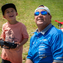 RC Pilot teaching a child to fly an RC Airplane