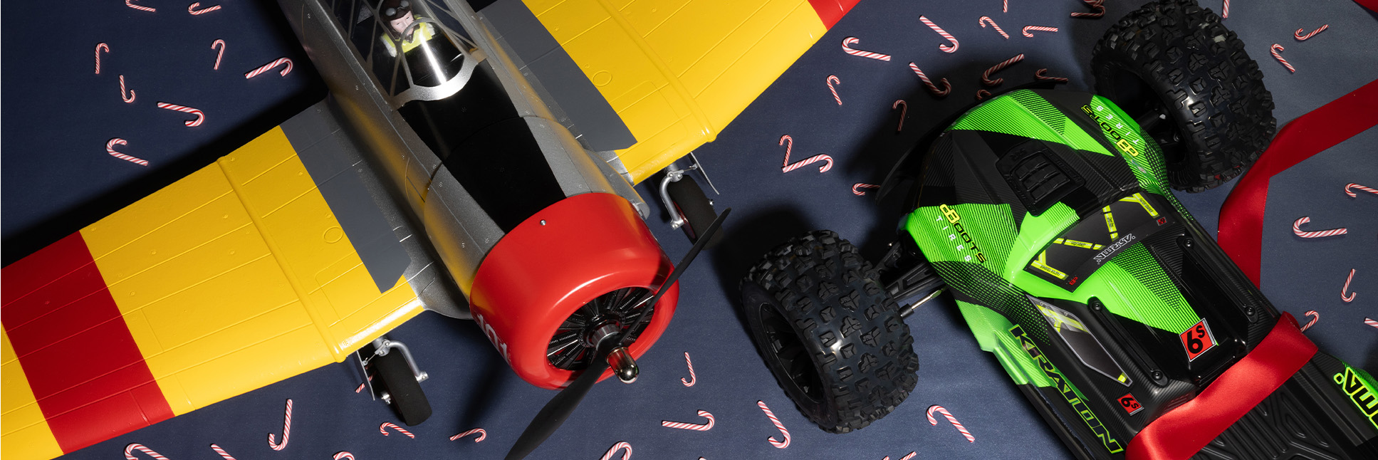 New Releases banner featuring the E-flite SNJ-5/AT-6 Texan 1.5m RC Airplane and the ARRMA 1/8 KRATON 4X4 6S BLX BRUSHLESS Ready-to-Run RC Speed Monster Truck (Green/Black) with a festive holiday themed background