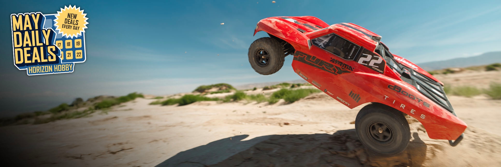 Action shot of ARRMA 1/10 FURY 2WD 4X4 Ready-to-Run Brushed RC Short Course Truck with the May Daily Deals Logo