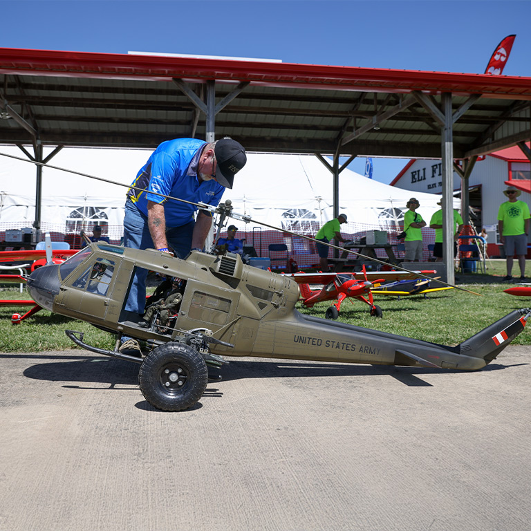 RC Scale Helicopter with pilot inspecting the aircraft
